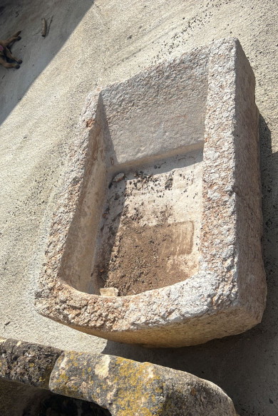 Pilón en piedra blanca con lavadera y medio punto.