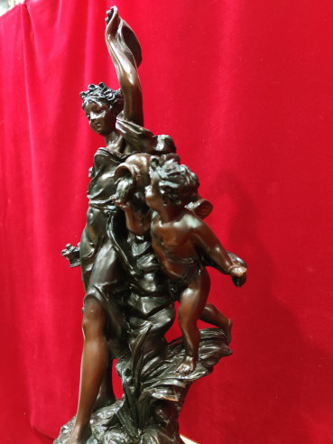 Figura de mujer y niño sobre reloj de mármol